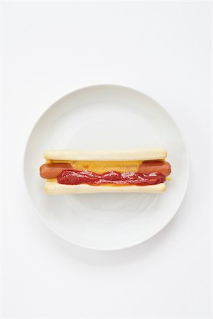still life of a hot dog with cheese and ketchup on plate Stock Photo - Rights-Managed, Code: 700-06714106