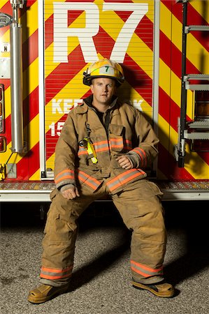 simsearch:700-06758378,k - Fire Fighter Sitting on Back of Fire Truck, Ontario Photographie de stock - Rights-Managed, Code: 700-06758379