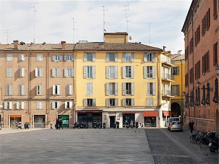 street scenes with motorcycles and bicycles - buildings lining courtyard in Modena Italy Stock Photo - Rights-Managed, Code: 700-06773314