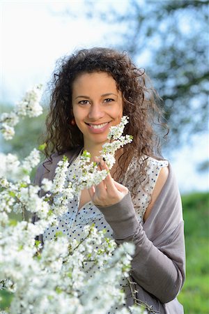 springtime - Close-up of a young woman beside a flowering blackthorn bush in spring, Germany Stock Photo - Rights-Managed, Code: 700-06808853