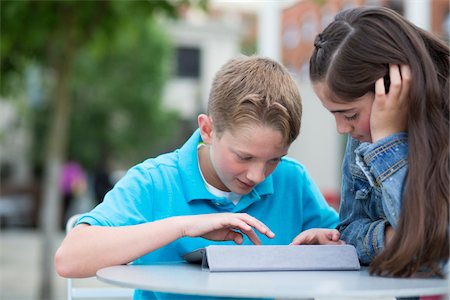 family city - Boy and girl playing on an iPad outside. Stock Photo - Rights-Managed, Code: 700-06808960