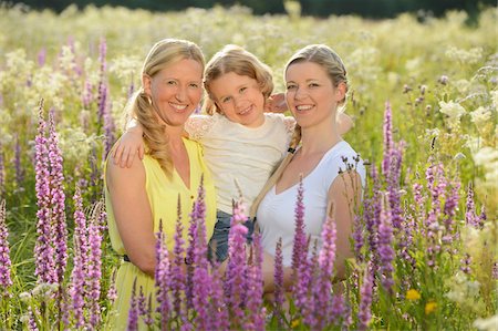 Close-up of a woman with her daughter and her mother in a flower meadow in summer, Bavaria, Germany. Stock Photo - Rights-Managed, Code: 700-06936124