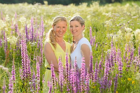 Close-up of a young woman with her mother in a meadow full of flowers in summer, Bavaria, Germany. Stock Photo - Rights-Managed, Code: 700-06936125