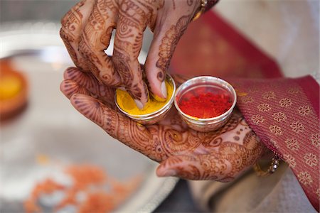 simsearch:700-03567853,k - Close-up of woman's hands with mendhi, using turmeric in small containers during Hindu wedding ceremony Stock Photo - Rights-Managed, Code: 700-06961002