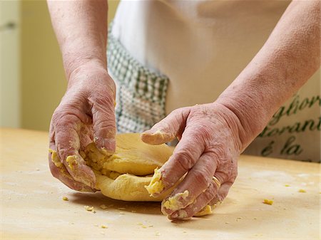 Close-up of elderly Italian woman's hands kneading pasta dough in kitchen, Ontario, Canada Stock Photo - Rights-Managed, Code: 700-07108332