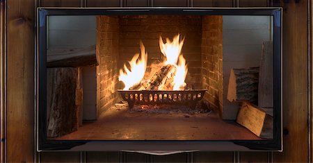 Close-up of widescreen TV mounted on wood panelled wall showing burning fire Foto de stock - Con derechos protegidos, Código: 700-07122853