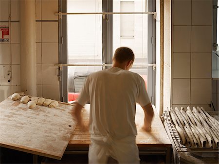 Male baker shaping baguette bread dough by hand in bakery, Le Boulanger des Invalides, Paris, France Stock Photo - Rights-Managed, Code: 700-07156238