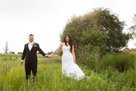 Portrait of Bride and Groom Holding Hands Outdoors Stock Photo - Rights-Managed, Code: 700-07199747