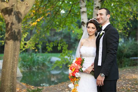 simsearch:700-07199878,k - Portrait of bride and groom standing outdoors next to trees in public garden, in Autumn, Ontario, Canada Stock Photo - Rights-Managed, Code: 700-07199864