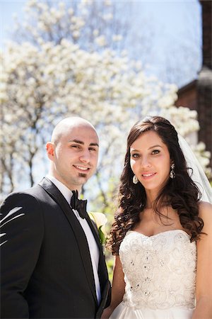 Close-up portrait of bride and groom standing outdoors on Wedding Day in Spring, smiling and looking at camera, Canada Stock Photo - Rights-Managed, Code: 700-07237614