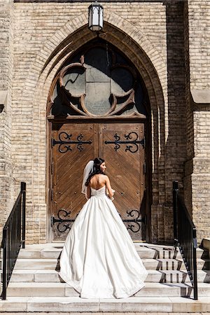 simsearch:700-03587091,k - Backview of bride in wedding gown, standing in front of church door on Wedding Day, Canada Stock Photo - Rights-Managed, Code: 700-07237611