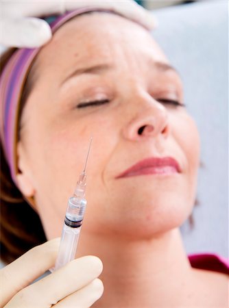 Doctor with Syringe about to Inject Patient Stock Photo - Rights-Managed, Code: 700-07487564