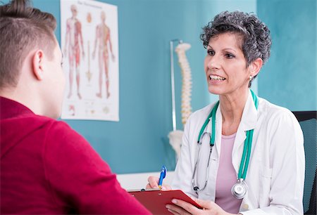 patient doctor talking senior - Doctor talking with Teenage Patient in Doctor's Office Stock Photo - Rights-Managed, Code: 700-07487619
