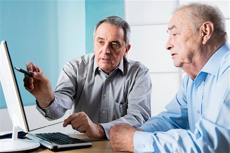 patient doctor talking senior - Senior, male doctor conferring with senior, male patient, using desktop computer in office, Germany Stock Photo - Rights-Managed, Code: 700-07529231