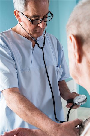 Senior, male doctor taking blood pressure of senior, male patient, in office, Germany Stock Photo - Rights-Managed, Code: 700-07529245