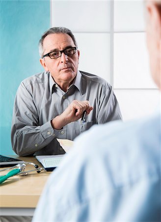 physician consulting backview - Senior, male doctor conferring with male patient in office, Germany Stock Photo - Rights-Managed, Code: 700-07529240