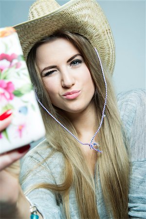 Young Woman taking Selfie, Studio Shot Stock Photo - Rights-Managed, Code: 700-07562376
