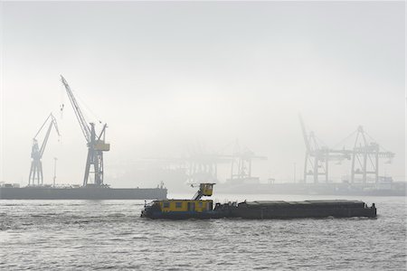 simsearch:700-03368682,k - View of Harbour with barge and container cranes at loading docks in morning mist, Hamburg, Germany Stock Photo - Rights-Managed, Code: 700-07599794