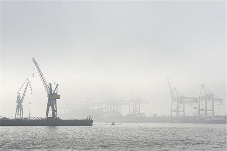 elbe - View of Harbour with container cranes at loading docks in morning mist, Hamburg, Germany Stock Photo - Rights-Managed, Code: 700-07599792