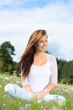 flowering fields - Close-up of a young woman sitting in a flower meadow in summer, Upper Palatinate, Bavaria, Germany Stock Photo - Rights-Managed, Code: 700-07760187