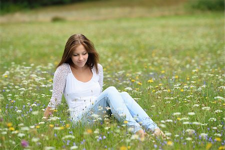 simsearch:700-06939632,k - Close-up of a young woman sitting in a flower meadow in summer, Upper Palatinate, Bavaria, Germany Stock Photo - Rights-Managed, Code: 700-07760206