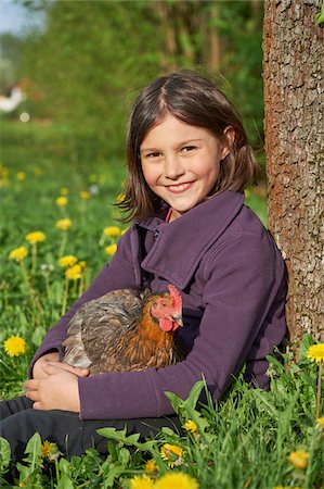 Portrait of Close-up of a Happy Girl with Chicken (Gallus gallus domesticus) in Meadow in Spring, Upper Patatinate, Stock Photo - Rights-Managed, Code: 700-08059857