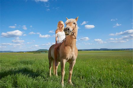 Portrait of young woman sitting on a Haflinger horse in a meadow in spring, Bavaria, Germany Stock Photo - Rights-Managed, Code: 700-08080580