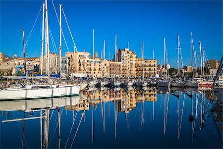 simsearch:700-08701917,k - Boats in the marina at Old Port of La Cala reflected in harbour on a sunny day in Palermo, Sicily in Italy Stock Photo - Rights-Managed, Code: 700-08701887