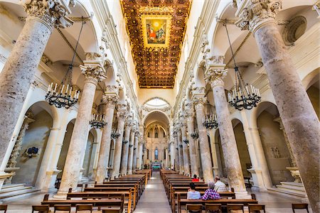 simsearch:614-06624688,k - Rows of marble pillars and chandeliers line the aisle to the main altar at the Church of the Holy Cross (Basilica di Santa Croce) in Lecce in Puglia, Italy Stock Photo - Rights-Managed, Code: 700-08739600