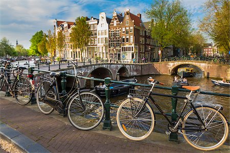 Bicycles parked along a bridge crossing the Leidsegracht Canal in the city center of Amsterdam, Holland Stock Photo - Rights-Managed, Code: 700-08973505