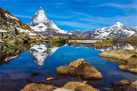 simsearch:600-07278765,k - Large rocks in a lake with reflection of the Matterhorn on a sunny day near Riffelsee at Zermatt, Switzerland Stock Photo - Rights-Managed, Code: 700-08986372