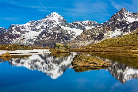 simsearch:600-07278765,k - Large rocks in a mountain lake with reflections of the Swiss Alps near Riffelsee at Zermatt, Switzerland Stock Photo - Rights-Managed, Code: 700-08986373