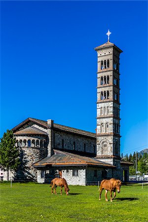 simsearch:862-06676770,k - Horses grazing on the grounds surrounding the Romanesque St Karl Church in St Moritz, Switzerland Stock Photo - Rights-Managed, Code: 700-08986384