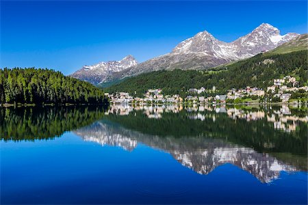simsearch:600-07278765,k - The resort town of St Moritz reflected in Lake St Moritz in the Engadin valley with the Swiss Alps in the background on a sunny day, Switzerland Stock Photo - Rights-Managed, Code: 700-08986380