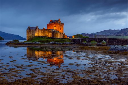 Eilean Donan Castle illuminated at dusk near Kyle of Lochalsh in Scotland, United Kingdom Stock Photo - Rights-Managed, Code: 700-08986526