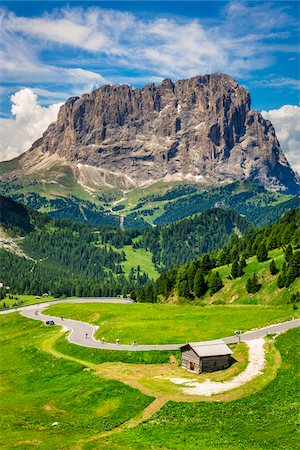 simsearch:700-03621231,k - Winding road through the grassy mountain side at the Gardena Pass with the mountains of the Dolomites in the background in South Tyrol, Italy Stock Photo - Rights-Managed, Code: 700-08986586
