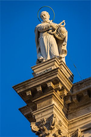 simsearch:700-08702035,k - Close-up of a religious statue on the Church of Saint Roch against a blue sky in Venice, Italy Stock Photo - Rights-Managed, Code: 700-08986693