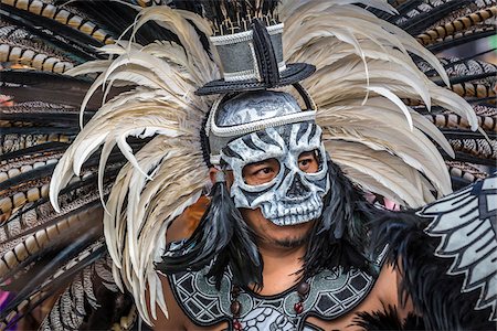 simsearch:614-02679643,k - Close-up of male, indigenous tribal dancer in black and white feathered headdress and skull mask at the St Michael Archangel Festival parade in San Miguel de Allende, Mexico Stock Photo - Rights-Managed, Code: 700-09088064