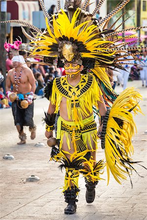 simsearch:614-02679643,k - Close-up of a male, indigenous tribal dancer wearing yellow feathered costume and headdress in the St Michael Archangel Festival parade in San Miguel de Allende, Mexico Stock Photo - Rights-Managed, Code: 700-09088090