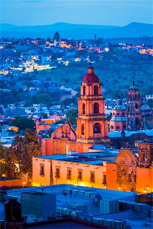 simsearch:400-04015133,k - The pink stone bell tower of the Oratorio de San Felipe Neri and overview of the city at dusk in San Miguel de Allende, Mexico Stock Photo - Rights-Managed, Code: 700-09088105