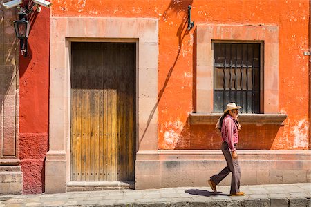 Man walking down street in front of traditional buildings in San Miguel de Allende, Mexico Stock Photo - Rights-Managed, Code: 700-09088115