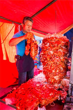 red interiors - Man preparing meat on large spit inside a tent at the Tianguis de los Martes (Tuesday Market) in San Miguel de Allende, Mexico Stock Photo - Rights-Managed, Code: 700-09088160