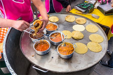 food cooking woman full - Close-up of a woman filling and frying tortillas at the Tianguis de los Martes (Tuesday Market) in San Miguel de Allende, Mexico Stock Photo - Rights-Managed, Code: 700-09088161