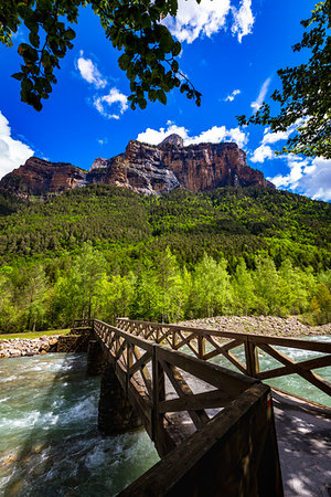 Footbridge crossing river with majestic mountain of the Pyrenees in the background in Ordesa y Monte Perdido National Park in Huesca, Aragon, Spain Stock Photo - Rights-Managed, Code: 700-09226506