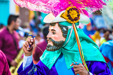 simsearch:841-07205349,k - Person in colorful costume wearing mask and playing castanets at a St Michael Archangel Festival parade in San Miguel de Allende, Mexico Stock Photo - Rights-Managed, Code: 700-09227118