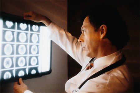 Male Doctor Looking at X-rays Stock Photo - Rights-Managed, Code: 700-00017026