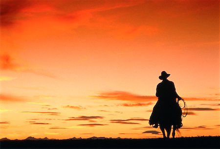 simsearch:700-00161937,k - Silhouette of Cowboy Riding Horse At Sunset Stock Photo - Rights-Managed, Code: 700-00017022