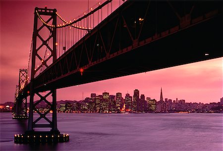 simsearch:862-08091471,k - Oakland Bay Bridge and Skyline At Sunset San Francisco, California, USA Stock Photo - Rights-Managed, Code: 700-00018701