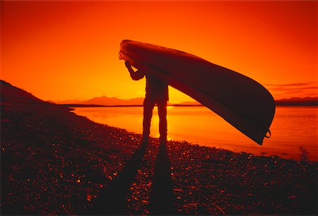 Silhouette of Person Portaging at Sunset, O'Grady Lake Northwest Territories, Canada Stock Photo - Rights-Managed, Code: 700-00024578