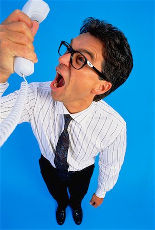 degrading - Businessman Yelling into Telephone Receiver Stock Photo - Rights-Managed, Code: 700-00025039